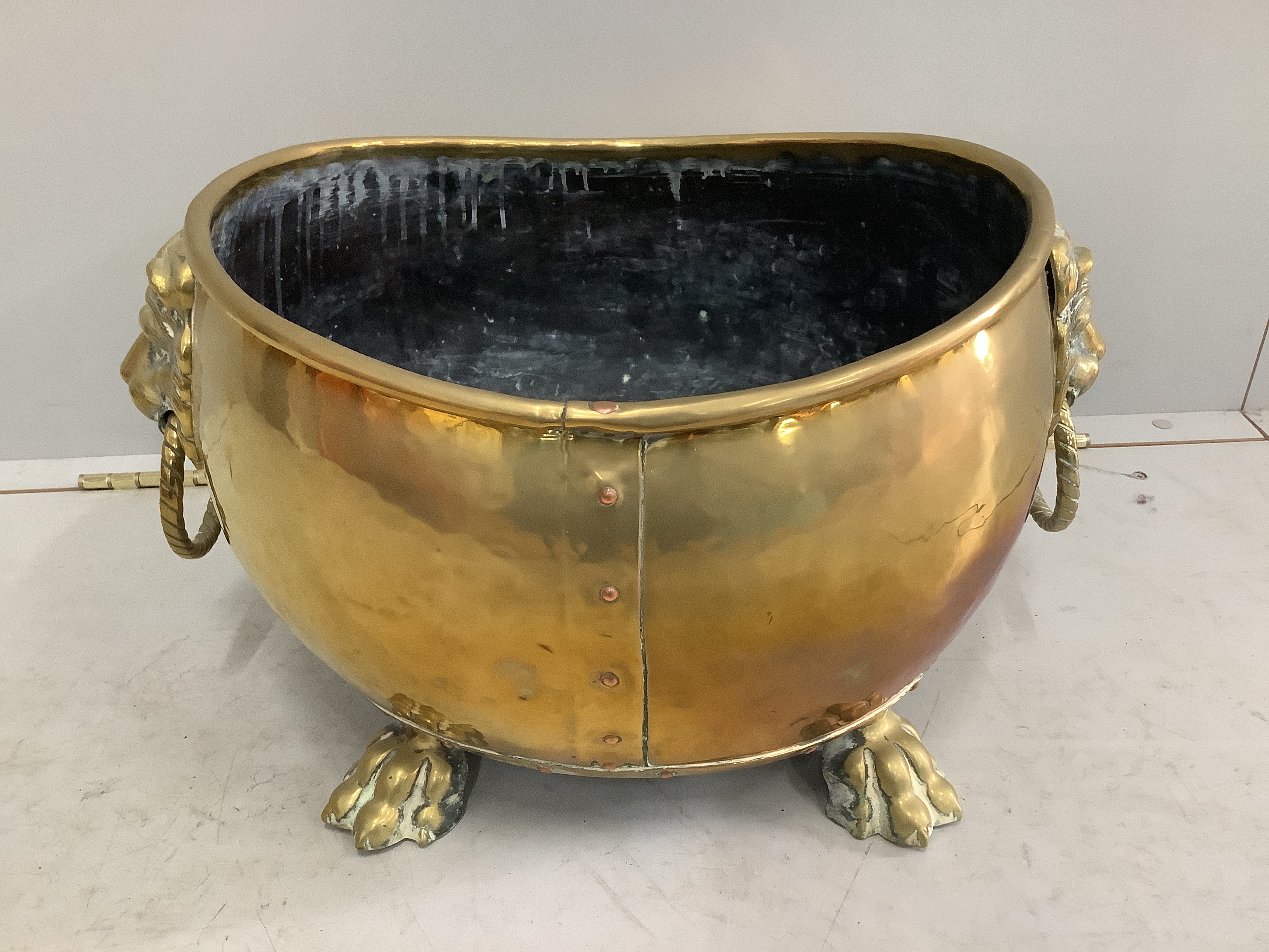 A 19th century Dutch oval and brass coal bin with lion mask ring handles, width 54cm, depth 40cm, height 30cm